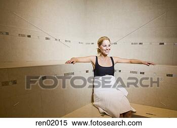 Stock Image - woman in bathrobe 
sitting in sauna. 
fotosearch - search 
stock photos, 
pictures, images, 
and photo clipart