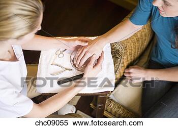 Stock Image - woman performing 
spa manicure. 
fotosearch - search 
stock photos, 
pictures, images, 
and photo clipart