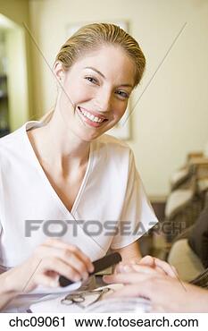 Stock Photography - woman performing 
spa manicure. 
fotosearch - search 
stock photos, 
pictures, images, 
and photo clipart