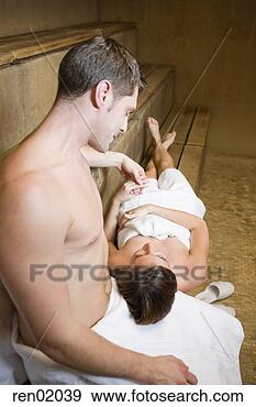 Stock Photograph - woman resting 
head on boyfriend’s 
lap in sauna. 
fotosearch - search 
stock photos, 
pictures, images, 
and photo clipart