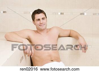 Stock Photo - young man sitting 
in sauna. fotosearch 
- search stock 
photos, pictures, 
images, and photo 
clipart