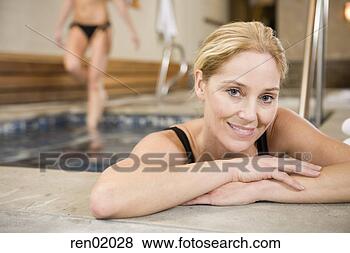 Stock Photo - young woman leaning 
of edge of hot 
tub. fotosearch 
- search stock 
photos, pictures, 
images, and photo 
clipart