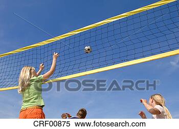 Stock Image - children (6-9) 
playing volleyball, 
low angle view. 
fotosearch - search 
stock photos, 
pictures, images, 
and photo clipart