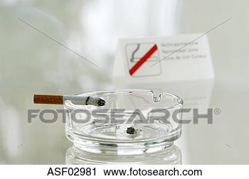 Stock Photography - cigarette in ash 
tray by non-smoking 
sign. fotosearch 
- search stock 
photos, pictures, 
images, and photo 
clipart