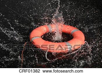 Stock Photo - life preserver 
floating on water, 
close-up. fotosearch 
- search stock 
photos, pictures, 
images, and photo 
clipart