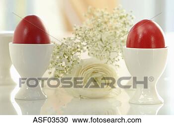Stock Photography - red easter eggs 
in white egg cups, 
close-up. fotosearch 
- search stock 
photos, pictures, 
images, and photo 
clipart