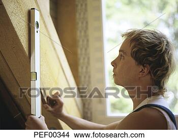 Stock Photo - carpenter using 
level tool. fotosearch 
- search stock 
photos, pictures, 
images, and photo 
clipart