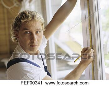 Stock Photography - man measuring 
window frame. 
fotosearch - search 
stock photos, 
pictures, images, 
and photo clipart