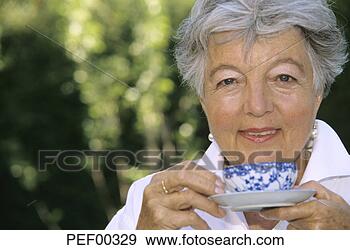 Stock Photograph - senior woman holding 
cup of tea, close 
up. fotosearch 
- search stock 
photos, pictures, 
images, and photo 
clipart