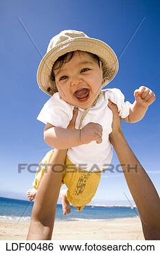Stock Photo - hands holding 
baby (6-9 months) 
into air, portrait. 
fotosearch - search 
stock photos, 
pictures, images, 
and photo clipart