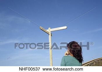 Picture - spain, la palma, 
woman standing 
in front of dirction 
sign. fotosearch 
- search stock 
photos, pictures, 
images, and photo 
clipart