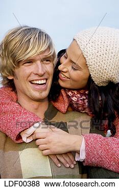 Stock Photo - woman embracing 
man, smiling, 
close-up. fotosearch 
- search stock 
photos, pictures, 
images, and photo 
clipart
