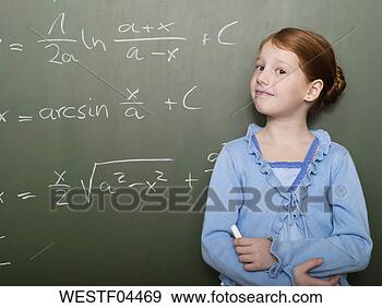 Stock Photograph - girl (4-7) standing 
by blackboard, 
portrait, close-up. 
fotosearch - search 
stock photos, 
pictures, images, 
and photo clipart