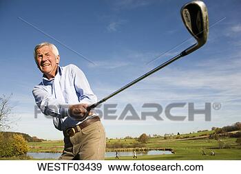 Stock Photograph - senior adult man 
holding golf club. 
fotosearch - search 
stock photos, 
pictures, images, 
and photo clipart