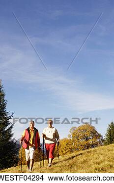 Stock Photo - senior couple 
nordic walking 
outdoors. fotosearch 
- search stock 
photos, pictures, 
images, and photo 
clipart