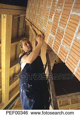 Stock Photo - carpenter measuring 
wall. fotosearch 
- search stock 
photos, pictures, 
images, and photo 
clipart