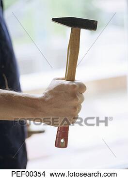 Stock Photo - man holding hammer, 
mid section. fotosearch 
- search stock 
photos, pictures, 
images, and photo 
clipart