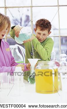 Stock Photo - boy and girl (8-11) 
in chemical lab, 
boy pouring liquid. 
fotosearch - search 
stock photos, 
pictures, images, 
and photo clipart