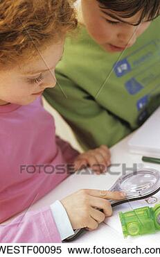 Banco de Imagem - menino,  menina, 
 olhar,  papel, 
 através,  magnificar, 
 vidro. fotosearch 
- busca de fotos, 
imagens e clipart
