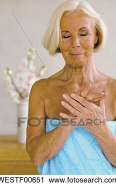 Stock Photography - senior woman wrapped 
in towel, eyes 
closed, smiling, 
portrait. fotosearch 
- search stock 
photos, pictures, 
images, and photo 
clipart