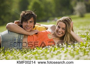 Stock Photo - young couple lying 
in meadow. fotosearch 
- search stock 
photos, pictures, 
images, and photo 
clipart