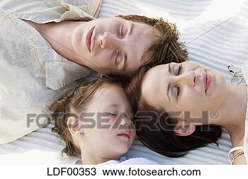 Stock Photo - family sleeping, 
elevated view. 
fotosearch - search 
stock photos, 
pictures, images, 
and photo clipart