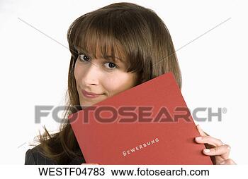 Stock Photo - young woman with 
face covered by 
application file, 
smiling, portrait. 
fotosearch - search 
stock photos, 
pictures, images, 
and photo clipart