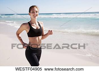 Stock Image - woman running 
on beach. fotosearch 
- search stock 
photos, pictures, 
images, and photo 
clipart