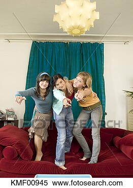 Stock Image - girls dancing 
on sofa. fotosearch 
- search stock 
photos, pictures, 
images, and photo 
clipart