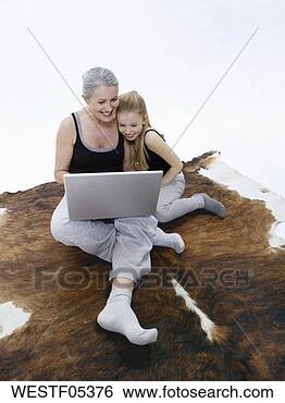 Stock Photo - grandmother and 
granddaughter 
using laptop, 
portrait. fotosearch 
- search stock 
photos, pictures, 
images, and photo 
clipart