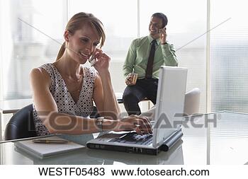 Stock Photo - business, teamwork, 
phoning and using 
a laptop. fotosearch 
- search stock 
photos, pictures, 
images, and photo 
clipart