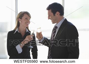 Stock Photography - business woman 
and business man 
toasting with 
sparkling wine. 
fotosearch - search 
stock photos, 
pictures, images, 
and photo clipart