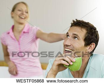 Stock Photo - couple, man holding 
cup. fotosearch 
- search stock 
photos, pictures, 
images, and photo 
clipart