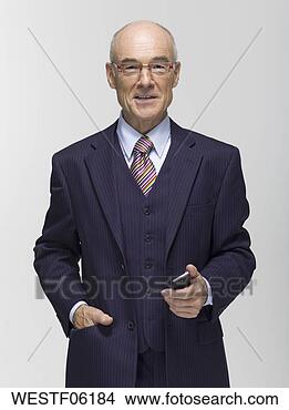 Banco de Imagem - homem negócios, 
 segurando,  móvel, 
 telefone. fotosearch 
- busca de fotos, 
imagens e clipart