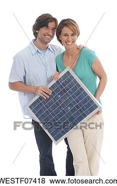 Stock Photo - couple holding 
solar panel. fotosearch 
- search stock 
photos, pictures, 
images, and photo 
clipart