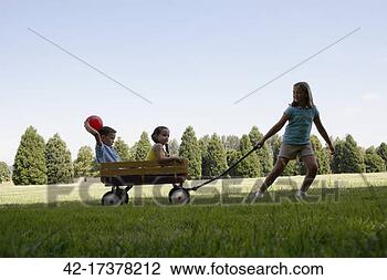 Stock Photo - girl pulling cart 
with boy and girl 
in park. fotosearch 
- search stock 
photos, pictures, 
images, and photo 
clipart