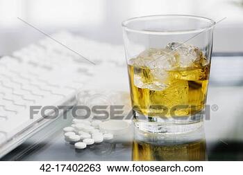 Stock Photo - glass of whiskey 
and pills on desk. 
fotosearch - search 
stock photos, 
pictures, images, 
and photo clipart