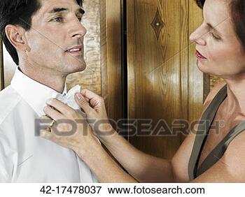 Picture - woman helping 
man with bow tie. 
fotosearch - search 
stock photos, 
pictures, images, 
and photo clipart