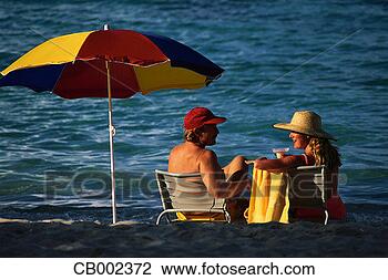 Stock Photo - beachgoers and 
multicolored umbrella. 
fotosearch - search 
stock photos, 
pictures, images, 
and photo clipart