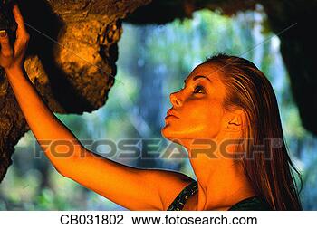 Stock Photo - woman touching 
cave wall. fotosearch 
- search stock 
photos, pictures, 
images, and photo 
clipart