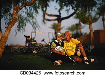Stock Image - older couple relaxing 
on putting green. 
fotosearch - search 
stock photos, 
pictures, images, 
and photo clipart