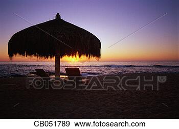 Stock Photograph - sun rising behind 
palapa. fotosearch 
- search stock 
photos, pictures, 
images, and photo 
clipart
