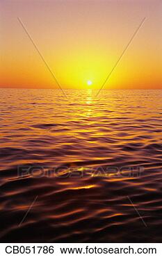 Stock Photo - sun rising over 
ocean. fotosearch 
- search stock 
photos, pictures, 
images, and photo 
clipart