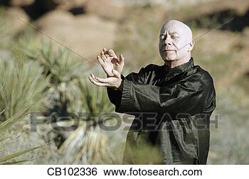 Stock Photo - man doing tai 
chi in desert. 
fotosearch - search 
stock photos, 
pictures, images, 
and photo clipart