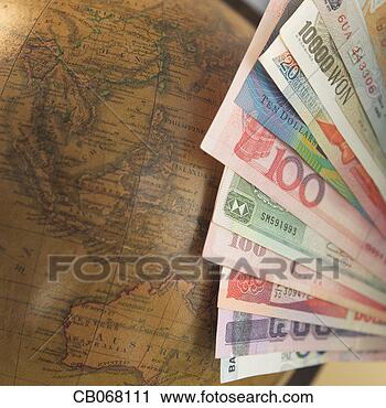 Stock Photography - asian and australian 
currencies next 
to globe. fotosearch 
- search stock 
photos, pictures, 
images, and photo 
clipart