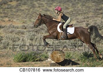 Stock Photo - girl jumping her 
horse. fotosearch 
- search stock 
photos, pictures, 
images, and photo 
clipart