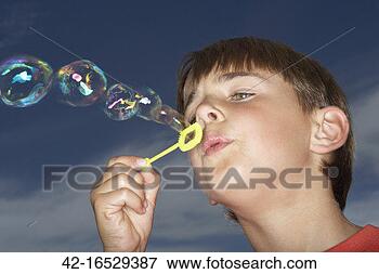Picture - young boy blowing 
bubbles. fotosearch 
- search stock 
photos, pictures, 
images, and photo 
clipart