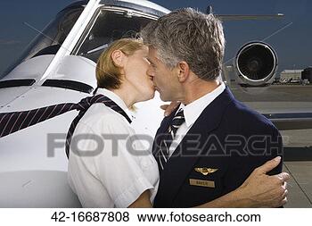 Stock Photo - stewardess and 
pilot kissing 
in front of airplane. 
fotosearch - search 
stock photos, 
pictures, images, 
and photo clipart