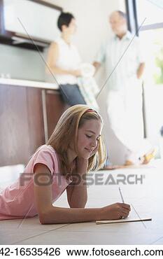 Stock Photo - teenage girl lying 
on kitchen floor 
and writing. fotosearch 
- search stock 
photos, pictures, 
images, and photo 
clipart