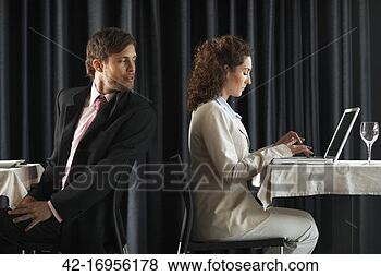 Stock Photo - businessman looking 
secretly to woman 
using laptop. 
fotosearch - search 
stock photos, 
pictures, images, 
and photo clipart